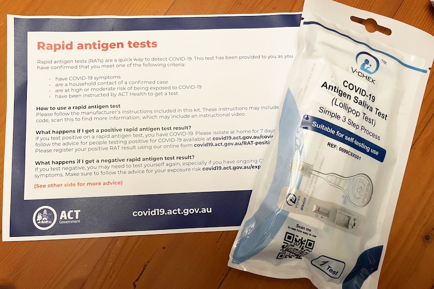 A packet of rapid antigen tests with an information sheet from the ACT government.