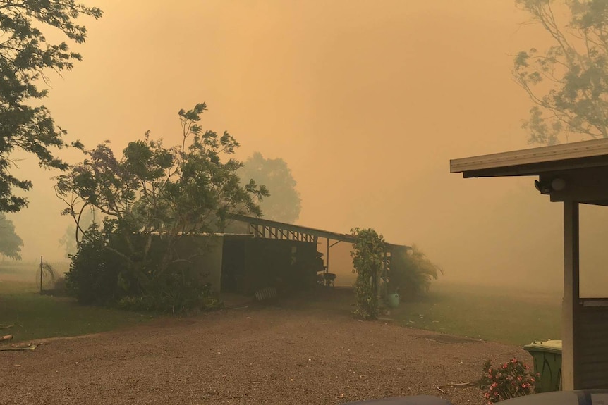 Smoke haze reduces visibility at a residential property.