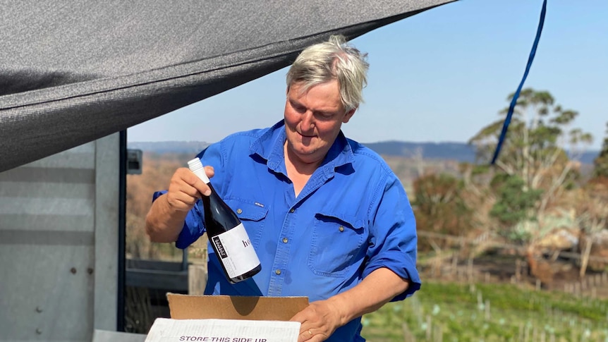 Adelaide Hills winemaker James Tilbrook holds a bottle.