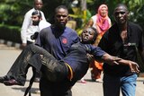 Woman is carried from Kenyan shopping mall after attack
