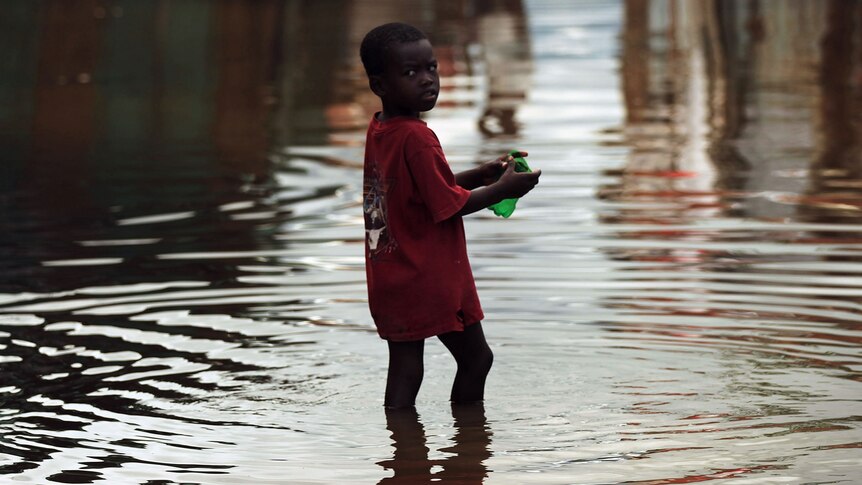 A child walks outside of his flooded home in Haiti (Getty Images: Spencer Platt)