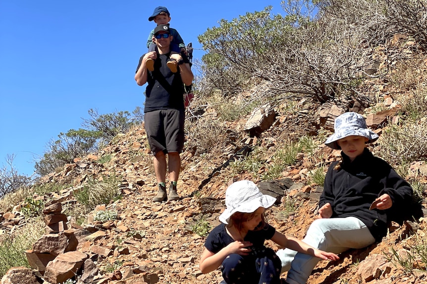 young family on desert trail