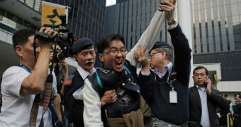 A man is scuffled by security force