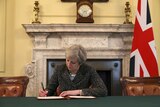 Theresa May in the cabinet office signs the official letter to trigger Brexit.