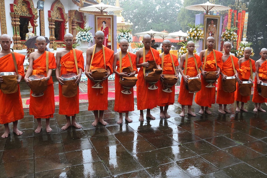 The boys wore traditional orange robes for the ceremony.