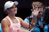 Ashleigh Barty claps with her racquet as she smiles and acknowledges the crowd at the Australian Open.
