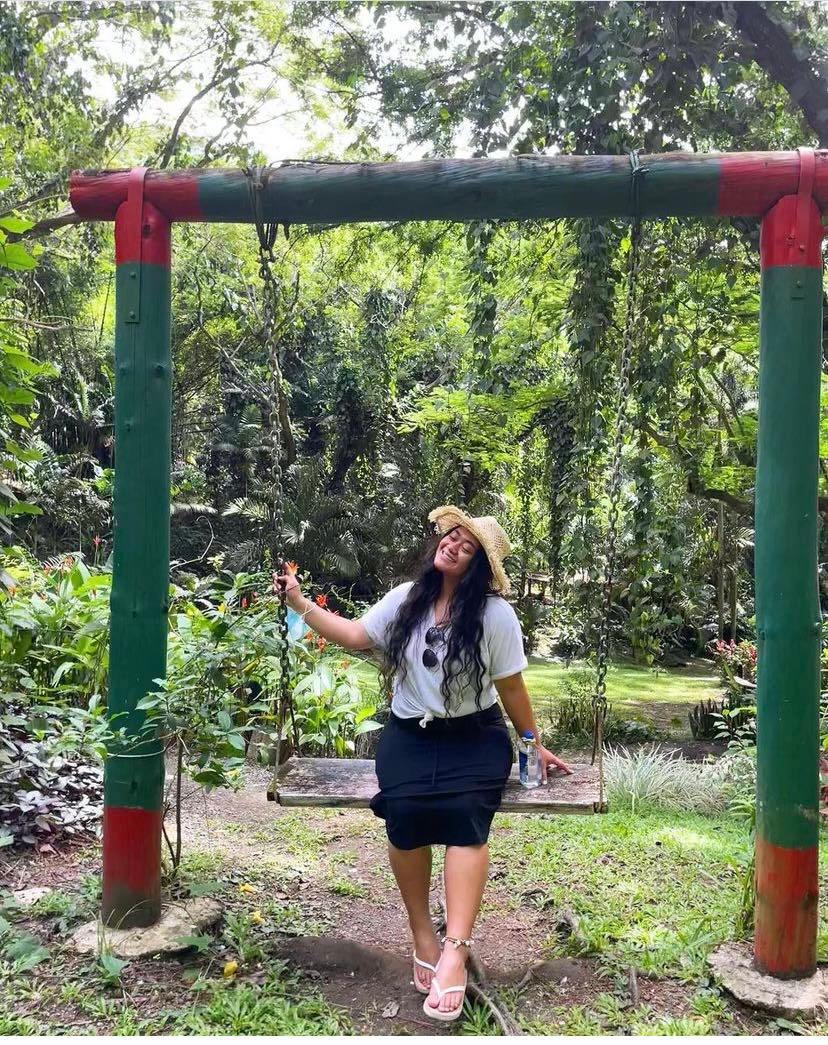 Claudia smiles on a swing in Fiji.