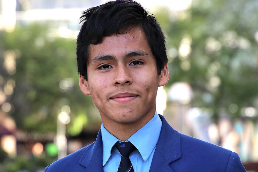 A boy in a royal blue school blazer.