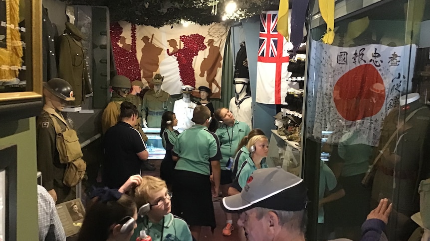 Children look at displays in war museum.