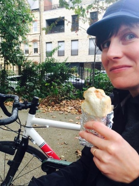 Michelle McGagh eating a sandwich while on a ride in London