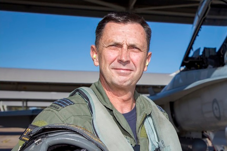 A man stands in his Royal Australian Air Force uniform.