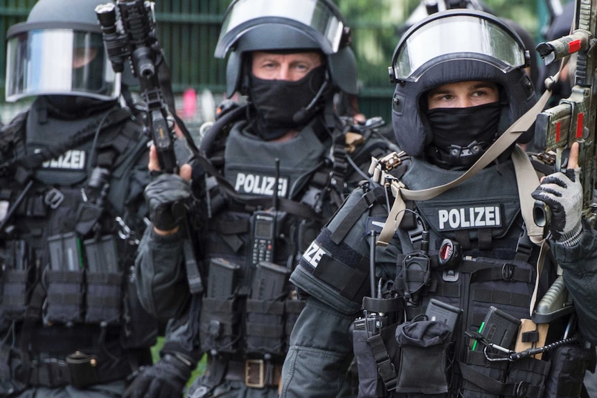 close up shot of three german police man in full tactical gear