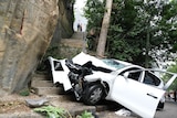 A smashed car at the bottom of a steep set of stairs