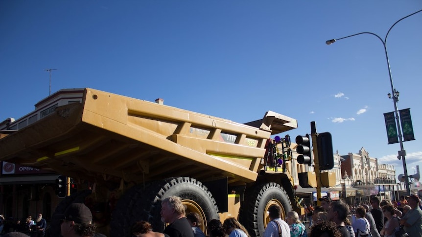 A large mining vehicle rolls down Hannan Street during the St Barbara's Parade.