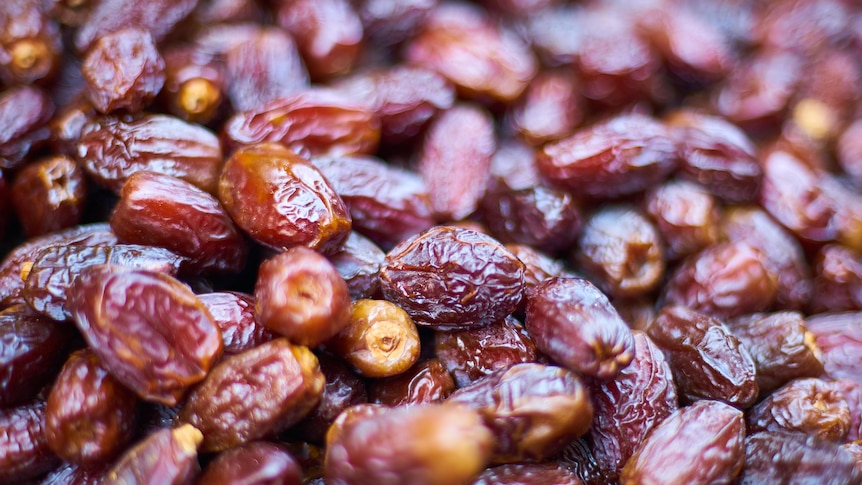 A close-up photo shows dozens of dried datse.