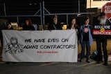 Climate change protesters block the front gates of premises of an Adani contractor.