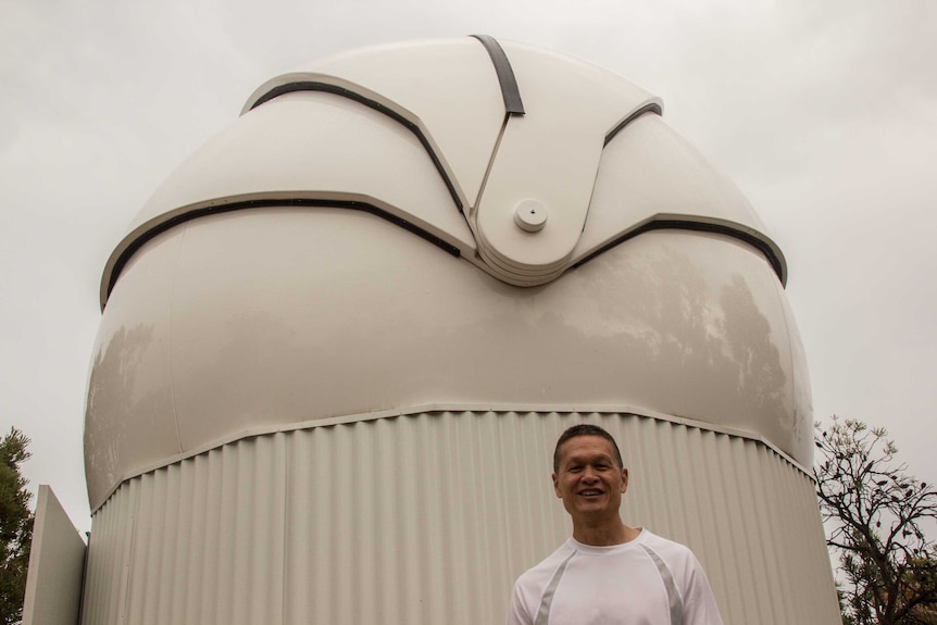 Professor Francis Chun with the Falcon telescope building