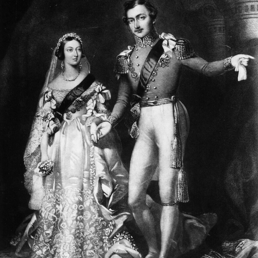 A black and white portrait of the Queen in her wedding dress