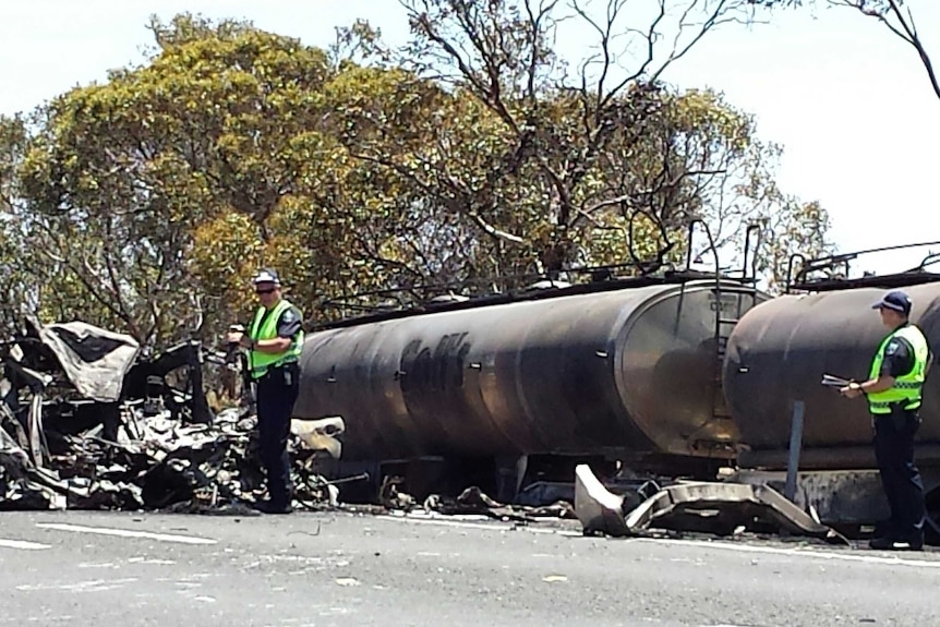 Police investigate a burnt out truck on the Dukes Highway.
