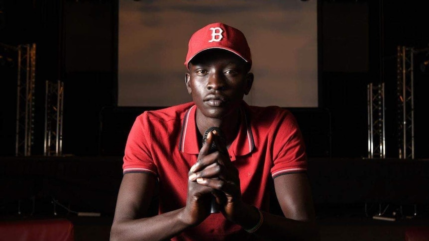 A man wearing a red baseball cap and red polo shirt