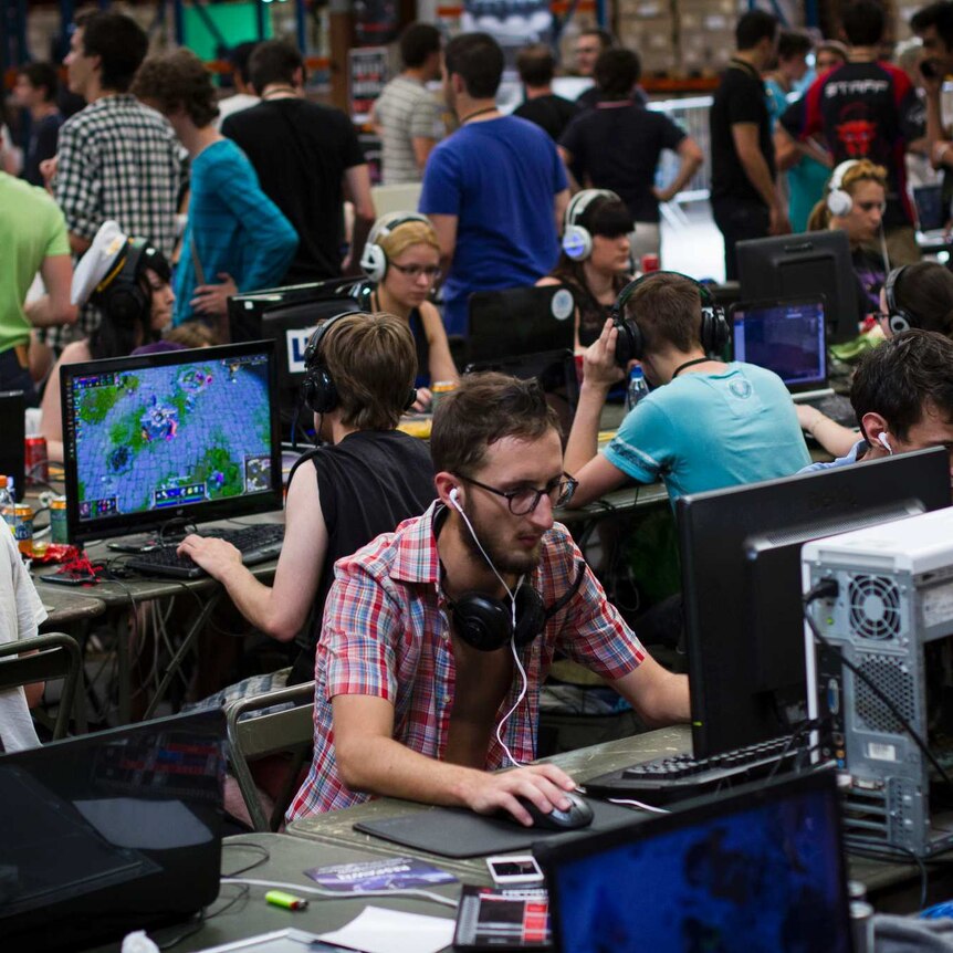 A large number of gamers and computer terminals at an e-sport event