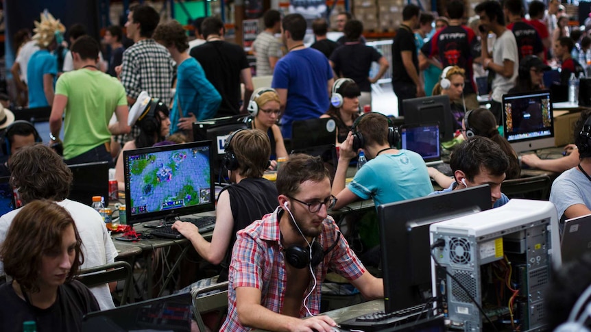 A large number of gamers and computer terminals at an e-sport event