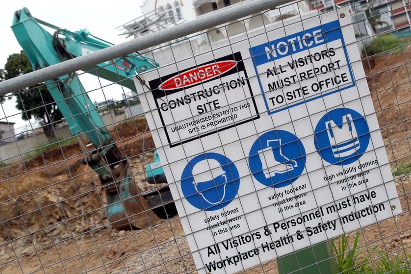 'Workplace Health and Safety Induction' sign at a building site