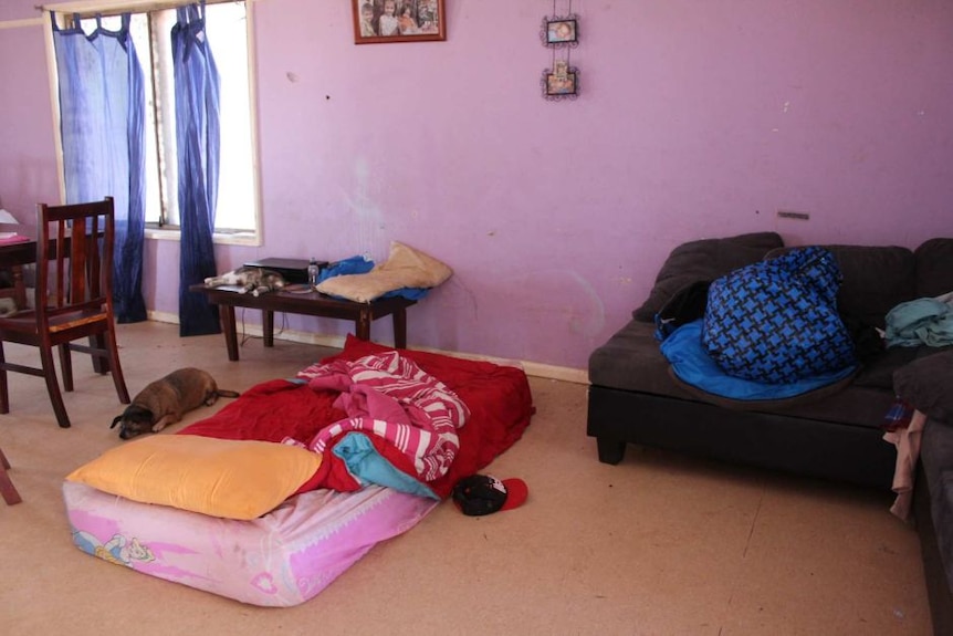 a mattress on the floor of a lounge room