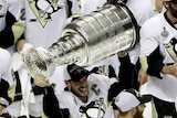Pittsburgh Penguins star Sidney Crosby celebrates with the Stanley Cup