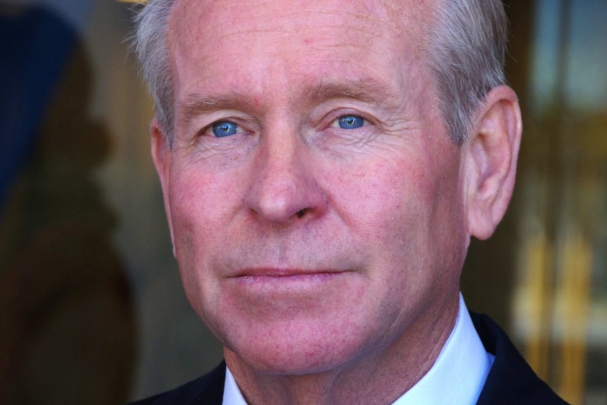 A tight shot of Colin Barnett's face as he listens to reporters ask questions.