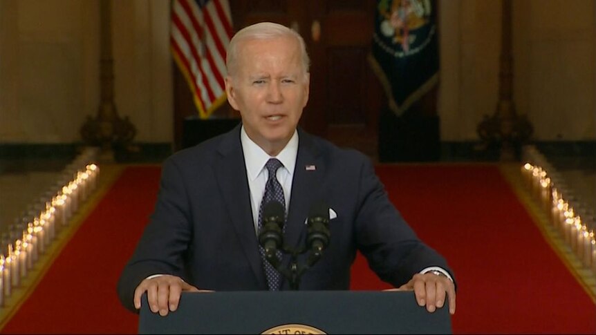 President Biden stands at podium whilst giving speech