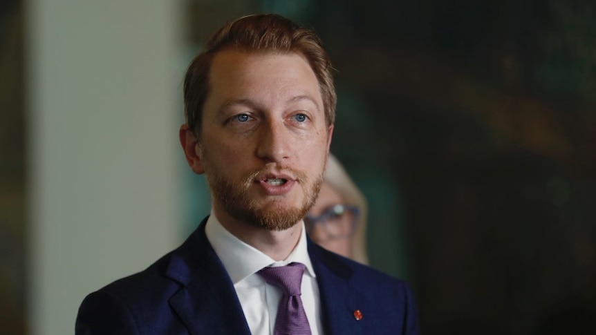 Senator James Paterson speaking in suit.