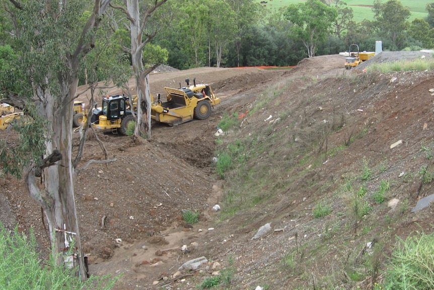 Earthmovers digging on a property 