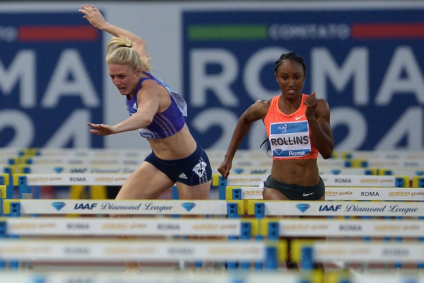Australia's Sally Pearson (L) falls in the women's 100m hurdles at the 2015 Rome Diamond League.