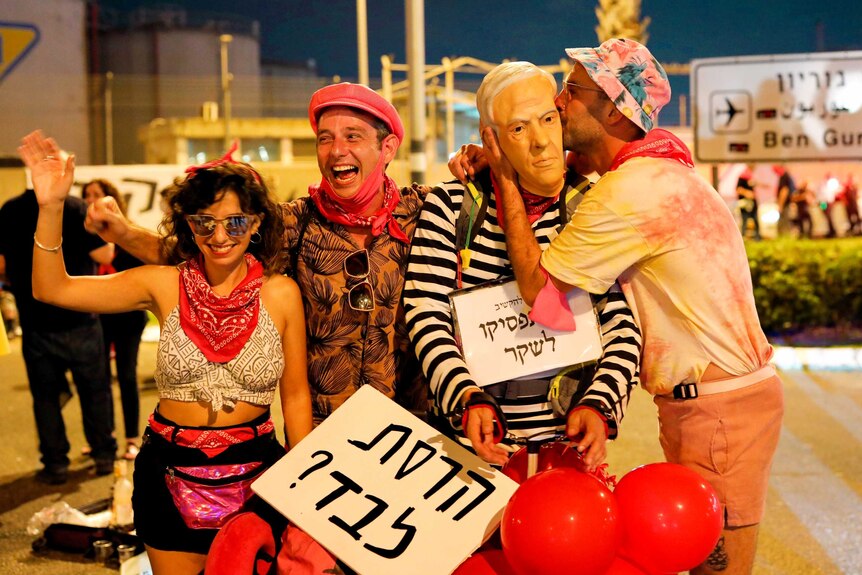 Protesters at an airport in Israel laughing together