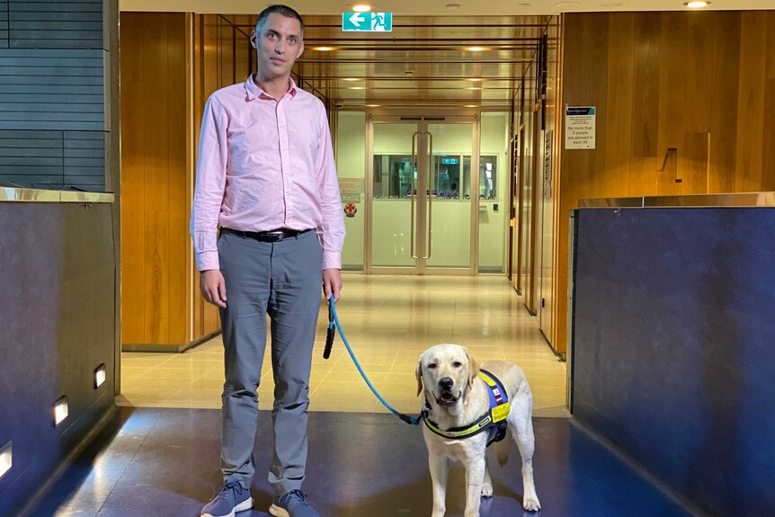 Dr Charles Alpren stands next to his dog Pippin.