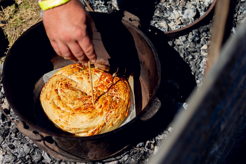 Damper cooking in a camp oven