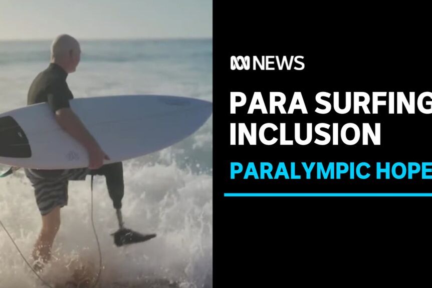 Para Surfing Inclusion, Paralympic Hopes: A man with a prosthetic leg enters the surf carrying a surfboard.