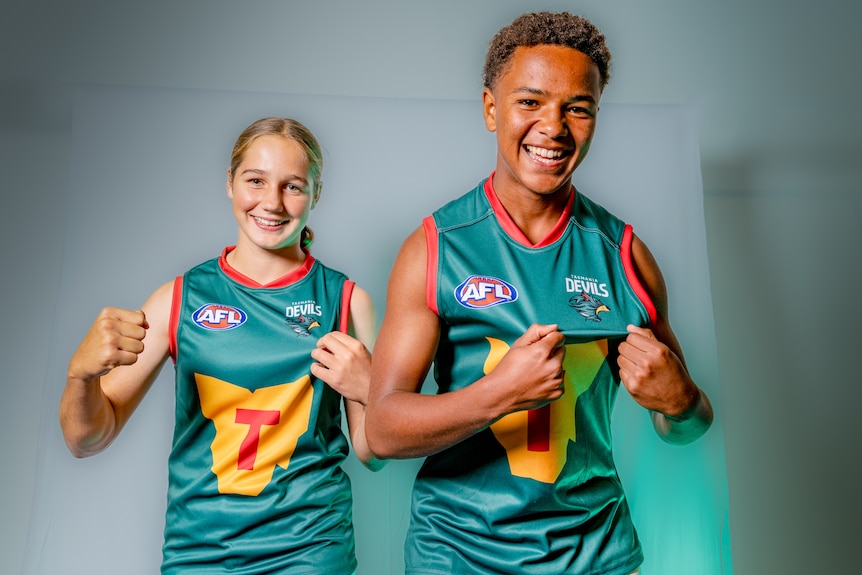 Tasmania Devils AFL team foundation jumper modelled by young male and female.