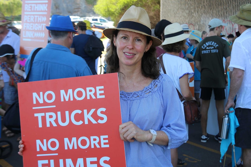 Protest organiser Katrina Cameron holds an anti-Roe 8 sign at the Fremantle gathering.