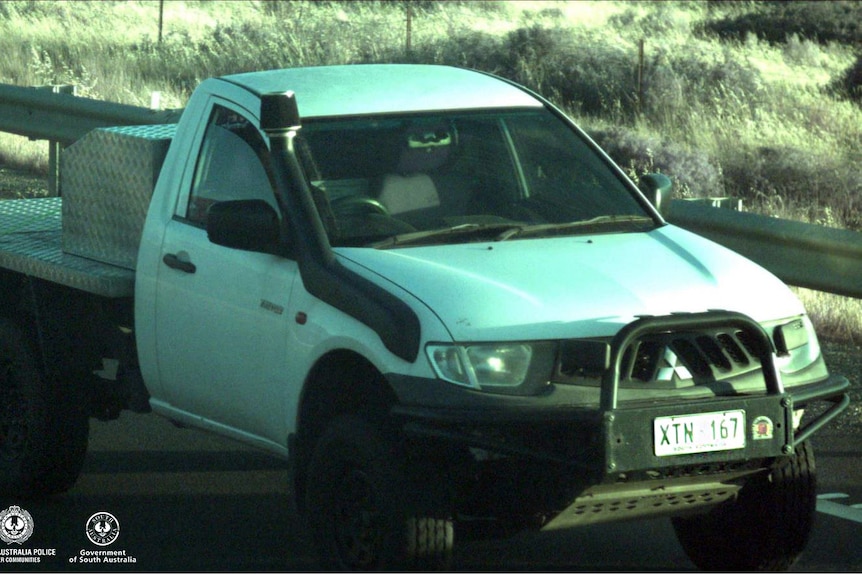 A white 2008 Mitsubishi Triton ute.