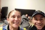 A Tasmania Police Facebook post featuring photo of officers and drunk man in background.