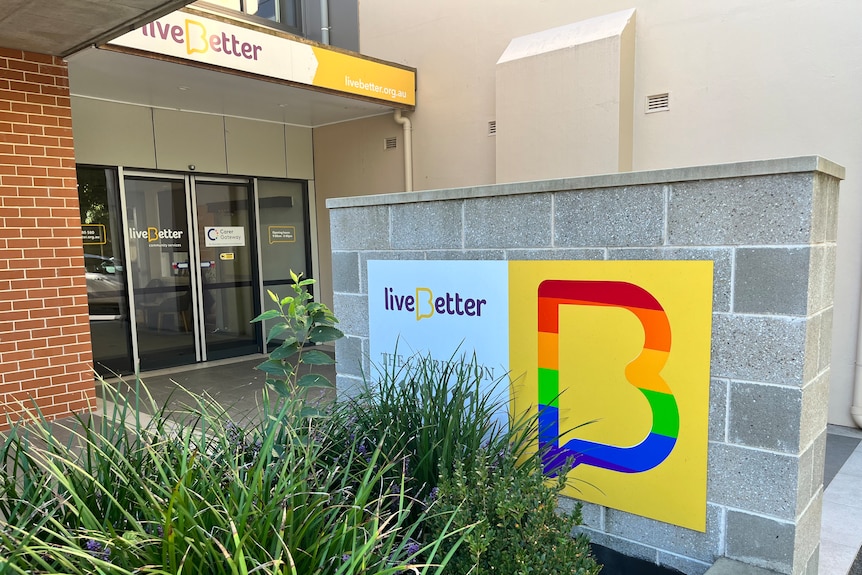 Exterior of building with Live Better signage and garden 