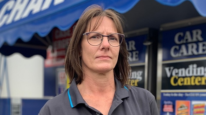 Belinda Bedin stands in front of her Mornington carwash business, dressed in a branded t-shirt.