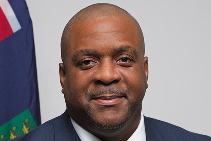 Man in a suit poses for a professional head shot.