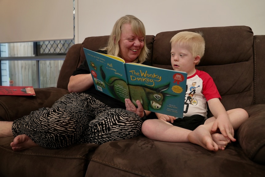 Cassandra Dinkelman reads to her son George, who has Down syndrome