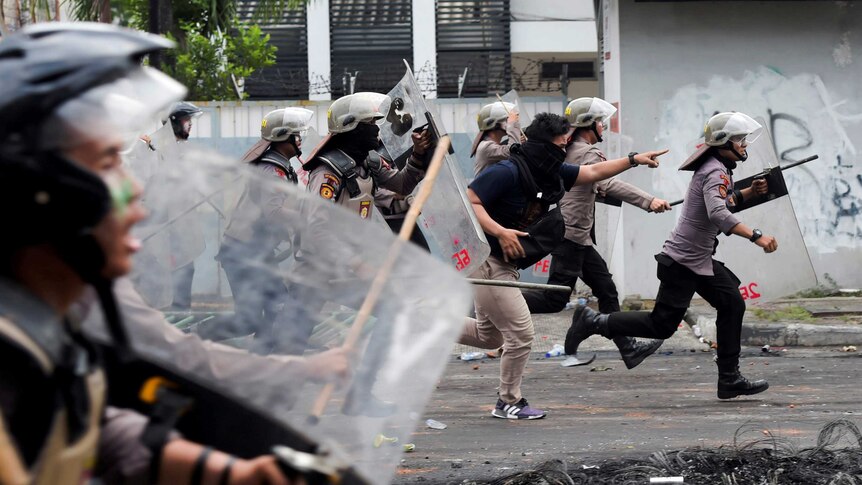 Police disperse protesters in Jakarta after the result of the presidential election was announced.
