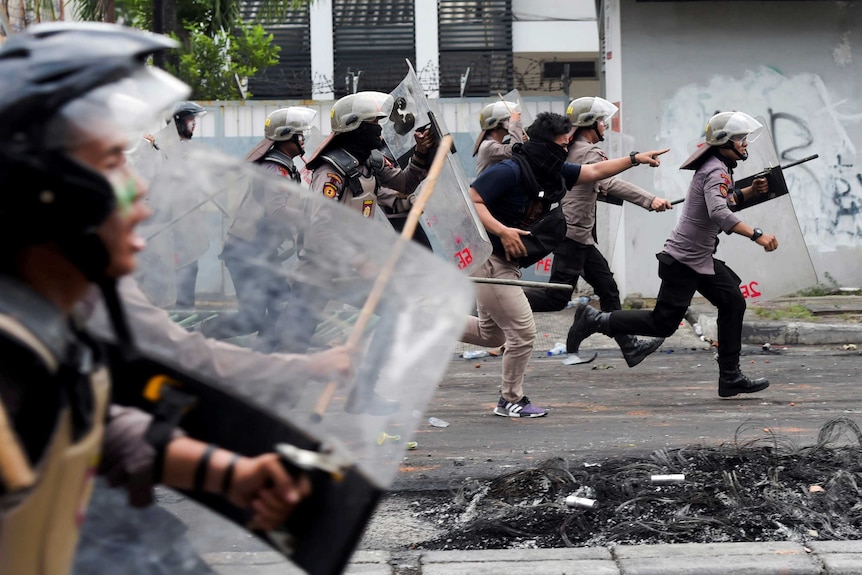 Police disperse protesters in Jakarta after the result of the presidential election was announced.