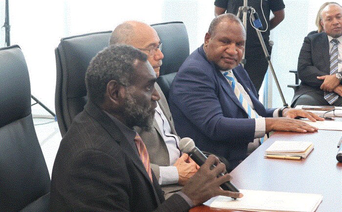 Papua New Guinea's Prime Minister James Marape and Bougainville's President, Ishmael Toroama sitting at a table talking