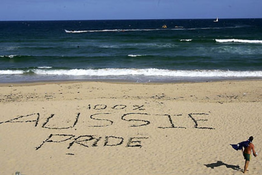 Aussie pride written on a beach floor